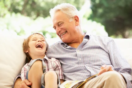 A grandfather and grandson reading together thanks to sleep apnea treatment in Pearland.